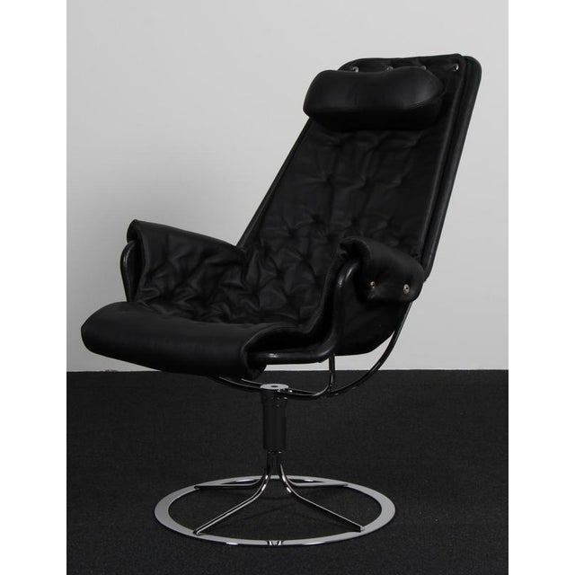Bruno Mathsson Jetson lounge chair with black leather. Frame in chromed steel. Made by DUX. This piece is attributed to...