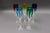 Faberge Crystal Lausanne Multicolored Champagne Flute Glasses Set Of 5. Measures approximately 1 7/8" long, 9" high.