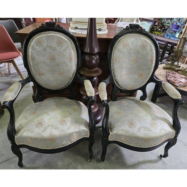 Pair of Napoleon III period armchairs in ebonized wood, circa 1850 Decorated with carvings Fine silk upholstery Cabriole legs