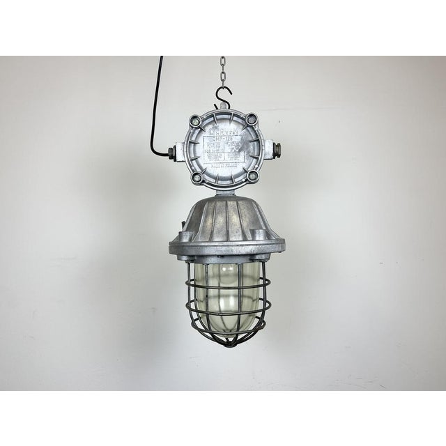 Large industrial factory hanging lamp made by Polam Wilkasy in Poland during the 1970s. It features a cast aluminium body,...