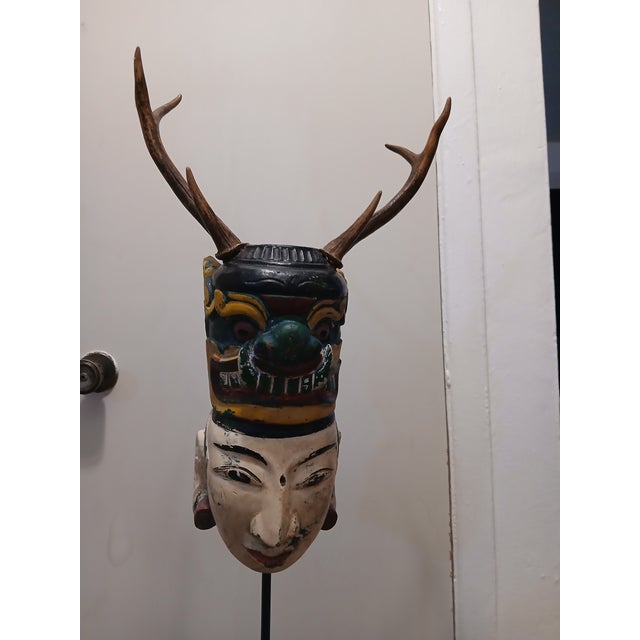 An exceptional and rare example of a "stacked" Indonesian ceremonial mask, this piece represents the duality of the human...