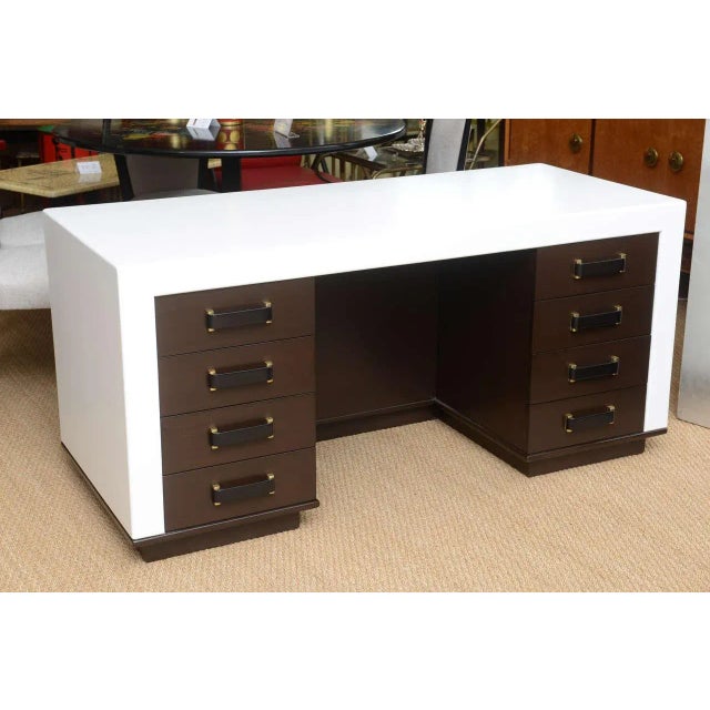 Rare Paul Frankl designed eight-drawer desk for the Johnson Furniture Co. of Grand Rapids, Michigan. Exposed concave cut-...