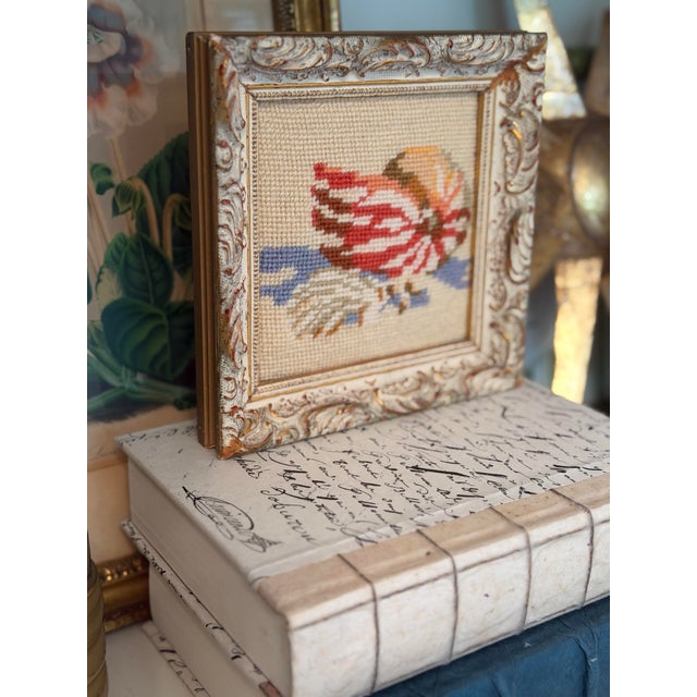 Charming vintage needlepoint featuring a beautifully stitched seashell in warm shades of coral, rust, cream, and soft...