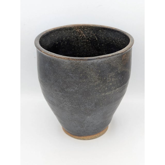 This vintage signed studio art pottery vase is a stunning example of Mid-Century Modern design. Made of gray ceramic with...