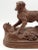 Large early 20th-Century Swiss Black Forest hand carved spaniel sporting or hunting setter dog. The dog is poised on a...