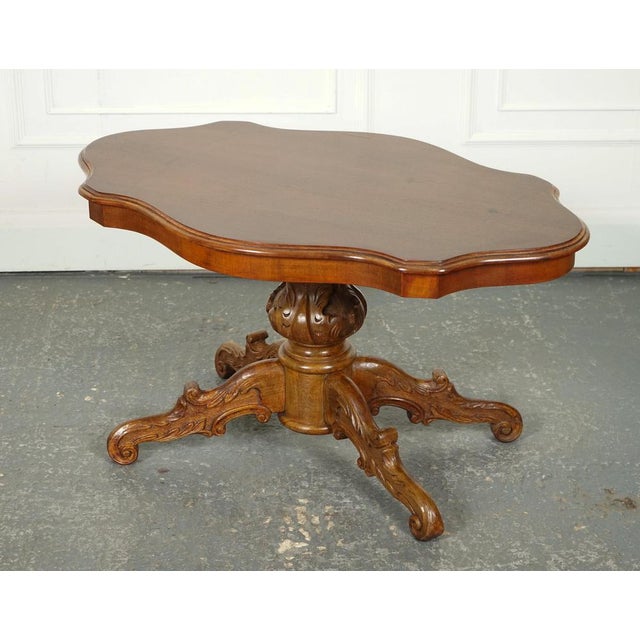 Vintage Italian Walnut Baroque Coffee Table. A vintage Italian walnut Baroque coffee table is a stunning and piece of...