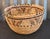 A beautifully handcrafted vintage coiled basket featuring intricate natural-fiber weaving and striking geometric...