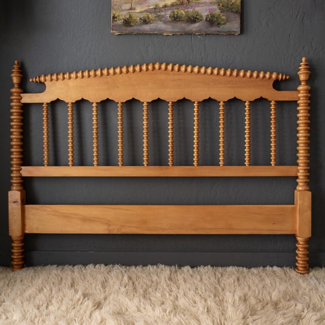 A 1940s Jenny Lind full/double walnut spindle, bobbin, or spool bed features a classical peaked pediment and its original...