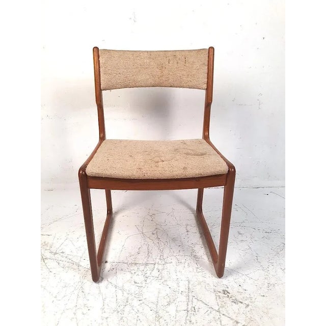 Stylishly simple set of 4 Danish modern dining chairs reminiscent of Benny Linden's designs. Sculpted teak frames with...