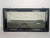 Oil on canvas in a wooden frame This oil on canvas painting in a wooden frame depicts a city view. The frame is dark, and...