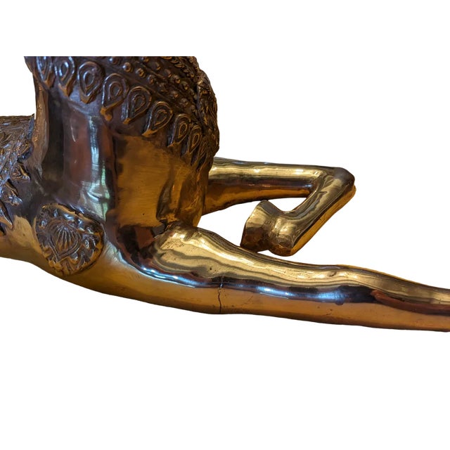 Large polished brass sculpture of a recumbent deer with gold patina, large antlers and floral ornaments, Hollywood...
