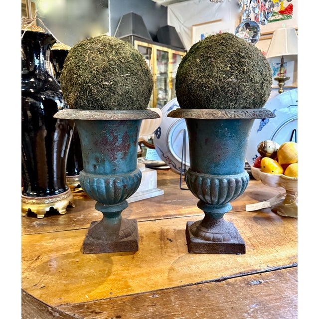 A superb pair of antique French cast iron garden urn planters circa 1880. These elegant campana jardinieres are the...