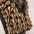 This figure is adorned in a cowrie shell vest, which is removable, and on a custom base. Ibeji figures, carved by the...