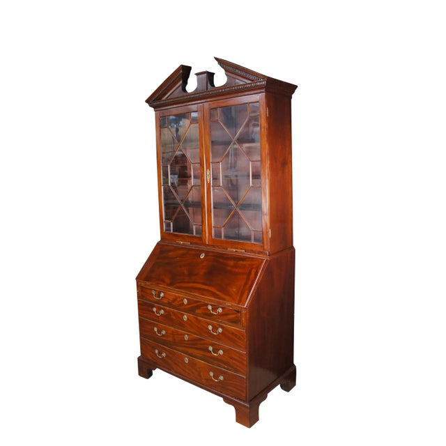 Late 18th Century George III Period Secretary Desk & Bookcase. Made from mahogany with a hooded pediment showcasing dentil...