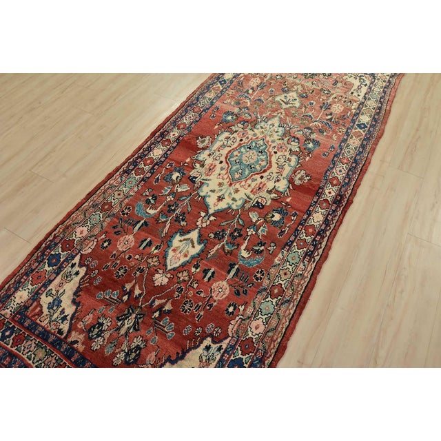 An authentic semi-antique, traditional Malayer runner hand-knotted with fine wool and natural dyes. This oriental rug...