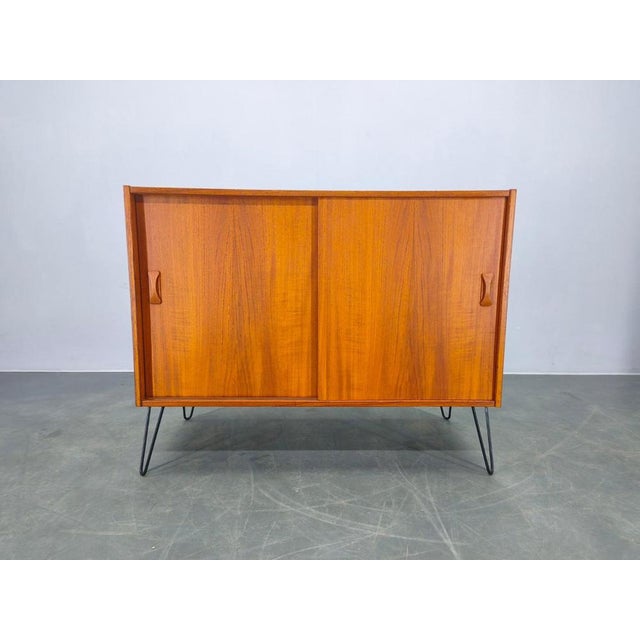 Refined danish mid century cabinet from the 1960s, executed in solid teak with teak veneered elements and plywood...