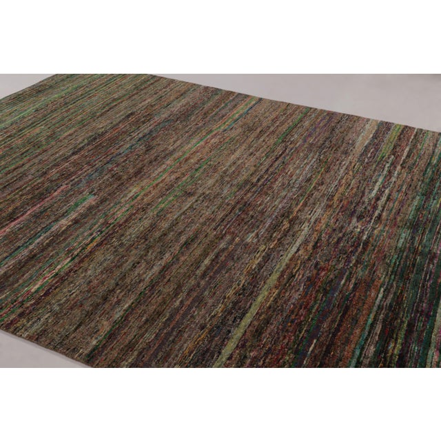Made with a luxurious hand-knotted silk, this modern 9x12 rug is a rich new addition to Rug & Kilim’s Textural rug...