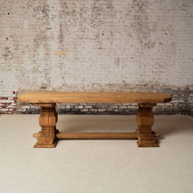 Bring rustic French character into your space with this early 20th century French oak trestle table, a substantial piece...