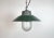 Industrial hanging lamp manufactured in Poland during the 1960s. It features a green enamel shade with a white enamel...