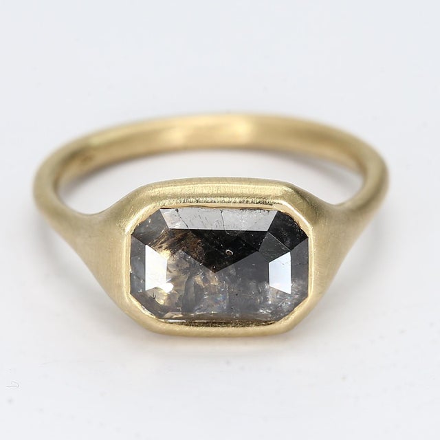 Here is a matte texture 14k Yellow Gold Ring with a 1.5ct bezel-set salt & pepper diamond in an east/west orientation 1x...