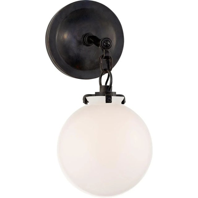 Katie Small Globe Sconce in Bronze with White Glass Designer: Thomas O'Brien Height: 12.5" Extension: 9.75" Backplate:...