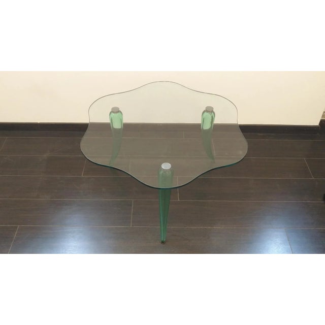 Table in blown glass and ground water green color, legs blown glass on satin steel frame, flat shaped and bevelled glass,...