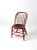 An antique Windsor chair with a classic bow-back silhouette, turned spindles, and gracefully turned stretchers. The chair...