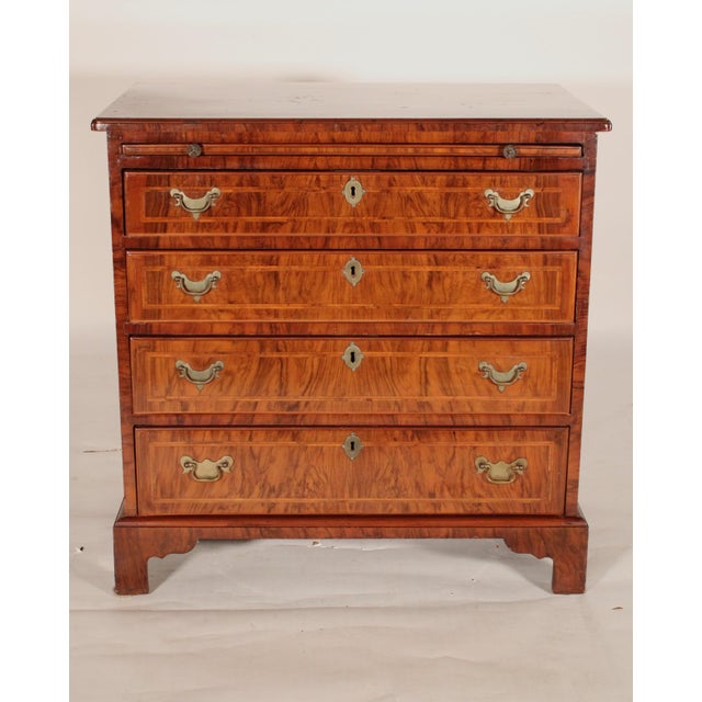 George I style burl walnut bachelor's chest, circa 1910. With a burl walnut top with herringbone inlay and molded front...