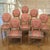 Set of 8 French Louis XVI Fruitwood Dining Chairs including 2 Armchairs boasts elegant Ottoman-style oval backs and...