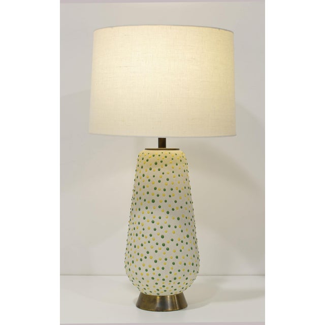 Elevate your living space with this exquisite pair of mid-century modern table lamps, uniquely adorned with green and...