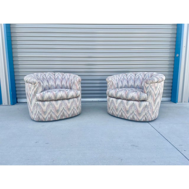 This pair of barrel-back swivel lounge chairs captures the glamor and comfort styled after the iconic mid-century designs...