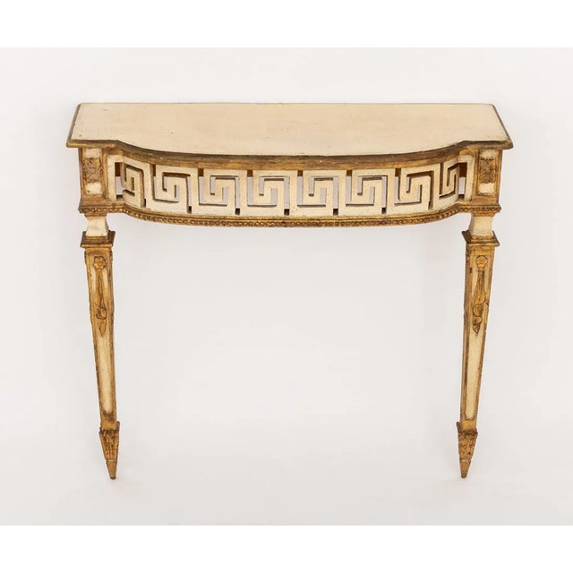 An elegant Italian Neoclassical style painted console table featuring a gracefully bowed front accented with a striking...