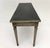 An exceptionally stylish neoclassical-style console table featuring a beautifully distressed painted finish, elegant...