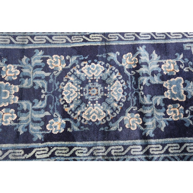 Antique Chinese Peking Rug with Floral Medallion in Deep Indigo color tones. This striking antique Chinese Peking rug...