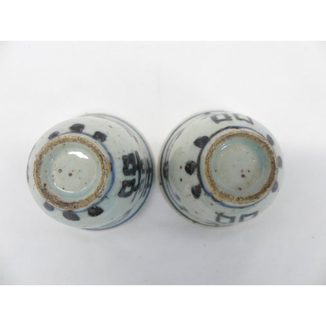 These are two hand thrown hand-painted matched antique Chinese teacups. They are blue and white porcelain with a double...