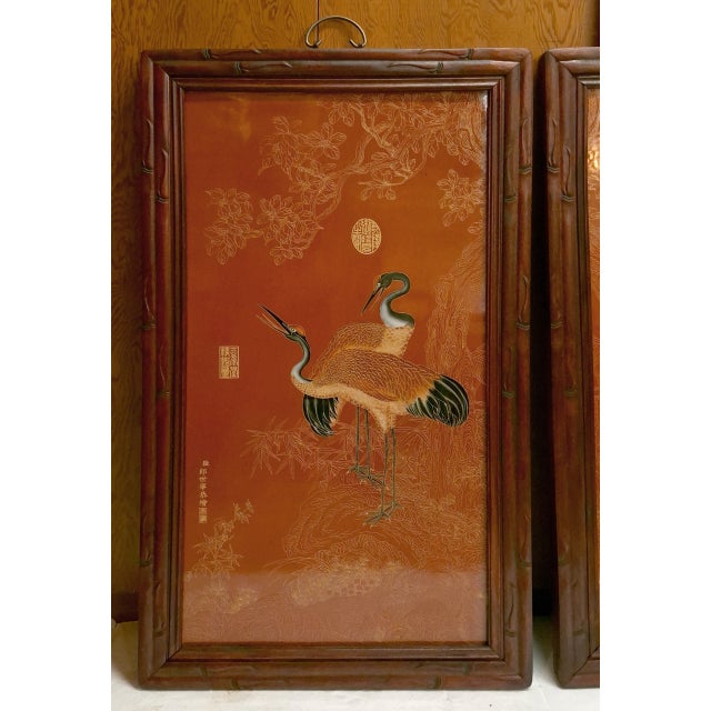 A matched pair of Chinese framed porcelain plaques of red crowned cranes, a finely caarved and detailed depiction of a two...