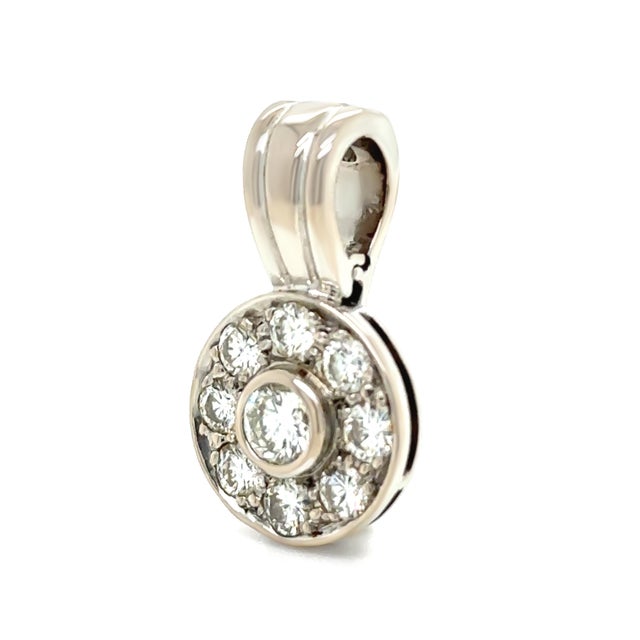 A beautifully crafted diamond pendant in 18ct white gold, featuring a striking central diamond surrounded by a halo of...