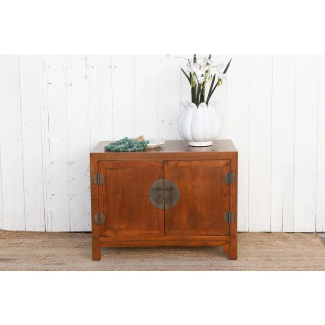 This farmhouse style walnut cabinet exudes rustic charm, boasting a beautiful warm brown patina enhanced by a carefully...