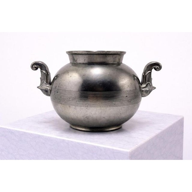 A refined and sculptural swedish art deco pewter vase produced by guldsmedsaktiebolaget (gab), dated 1939. This elegant...