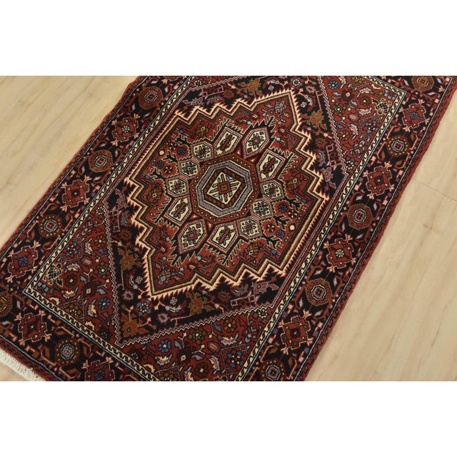 An authentic vintage traditional Goltogh rug hand-knotted with fine wool and natural dyes. This intricately woven rug...