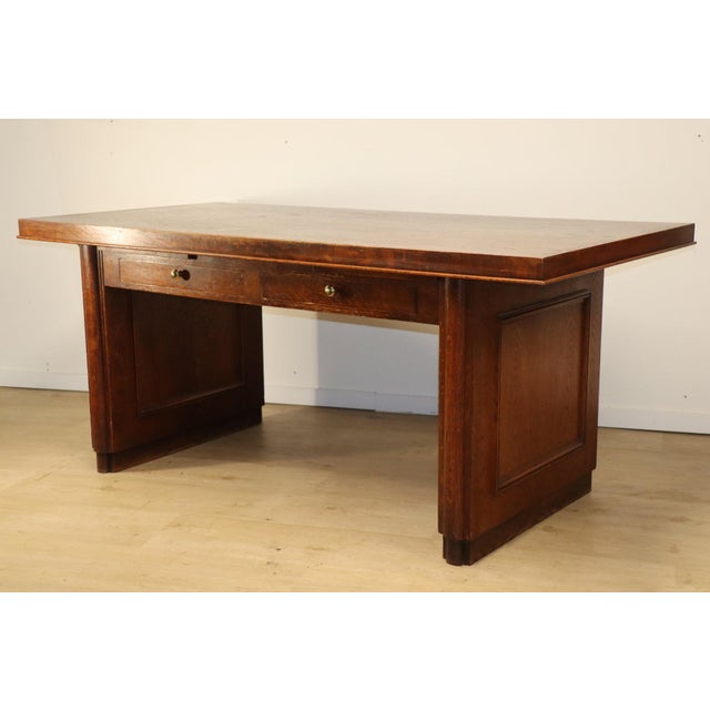 A solid oak desk with a modernist look, designed in the 1940s in the Art Deco style, boasting a characteristic geometric...
