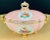 An exquisite and decorative Italian porcelain jewelry box. Hand painted in pink, gold and white with flower motifs, the...