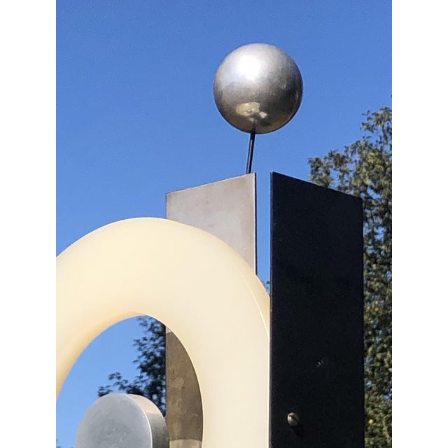 An aerial, postmodernist, pop, kinetic, free-form, space age tabletop sculpture. Black lacquered wood base, geometric...