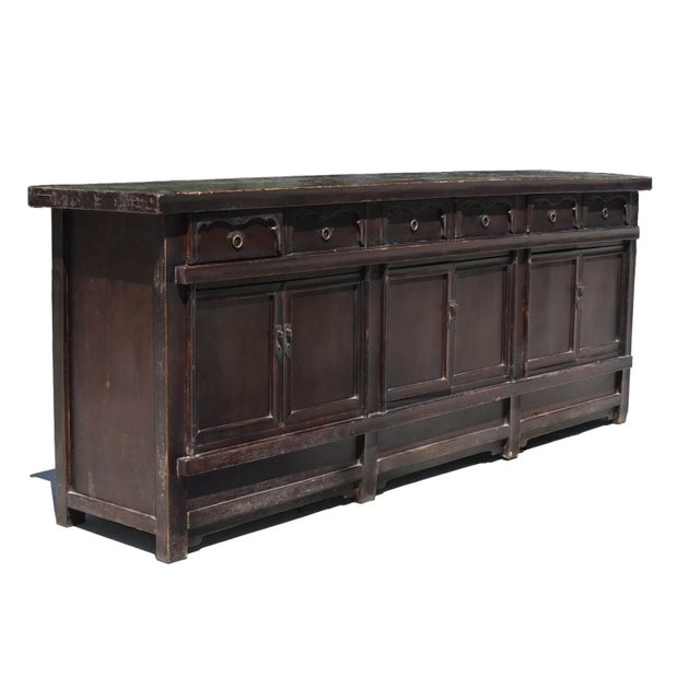 A monumental 9 feet 8 inches solid wood sideboard from early 19th century. The top is made of solid boards in 2.5"...