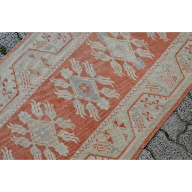 This is a vintage Turkish Oushak rug from the 1960s. The piece was hand-knotted.