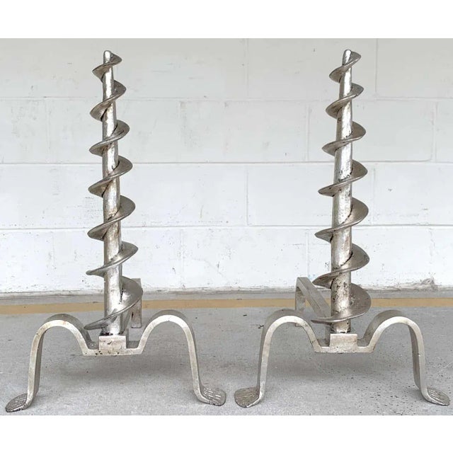 Pair of French modern silvered iron andirons, each one a tall spiral resting on elongated pad feet. Each Andiron measures...