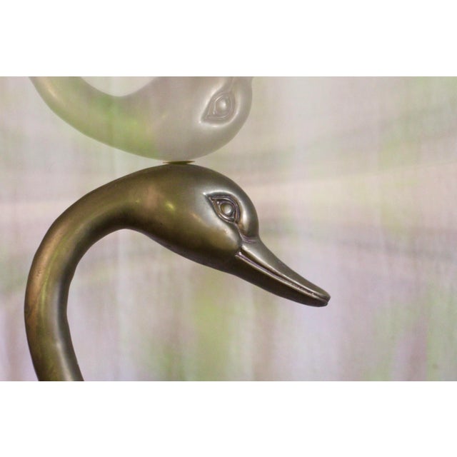 A unique brass swan base with a round glass top. Dining room size. Large beveled glass top in a large size perfect for...