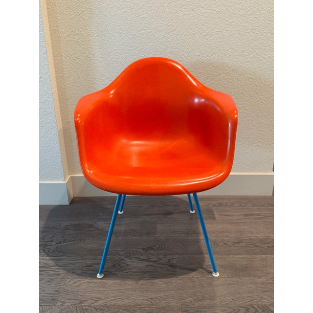 Beautiful Herman Miller Eames molded chair in orange/red. New fiberglass version which has the same desirable look as the...
