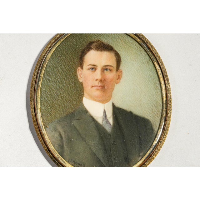 A beautifully preserved glimpse into the elegance of the early 20th century, this antique portrait miniature dates to 1919...