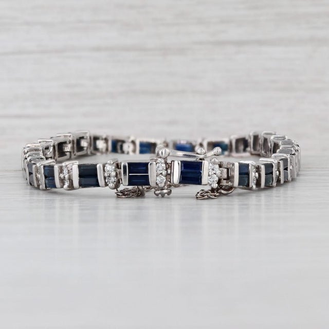 Gemstone Information: - Natural Sapphires - Total Carats - 6.70ctw Cut - Baguettes Color - Dark Blue Treatment - Heated -...